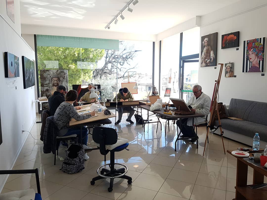 Working together during a drawing and painting class.
