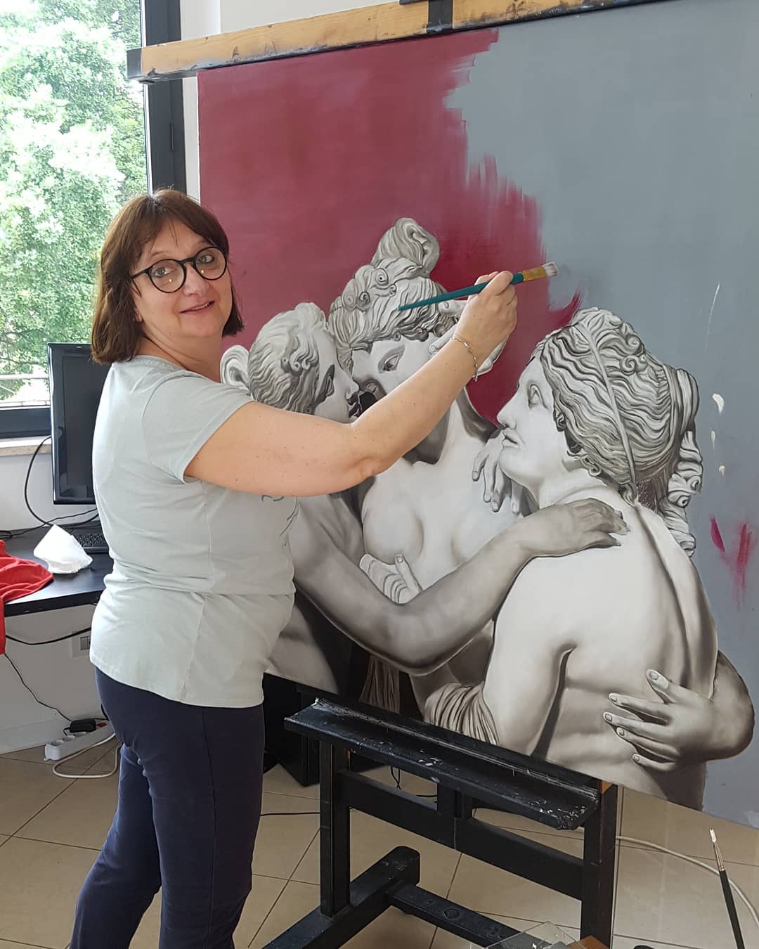 Participant working on a painting during a course