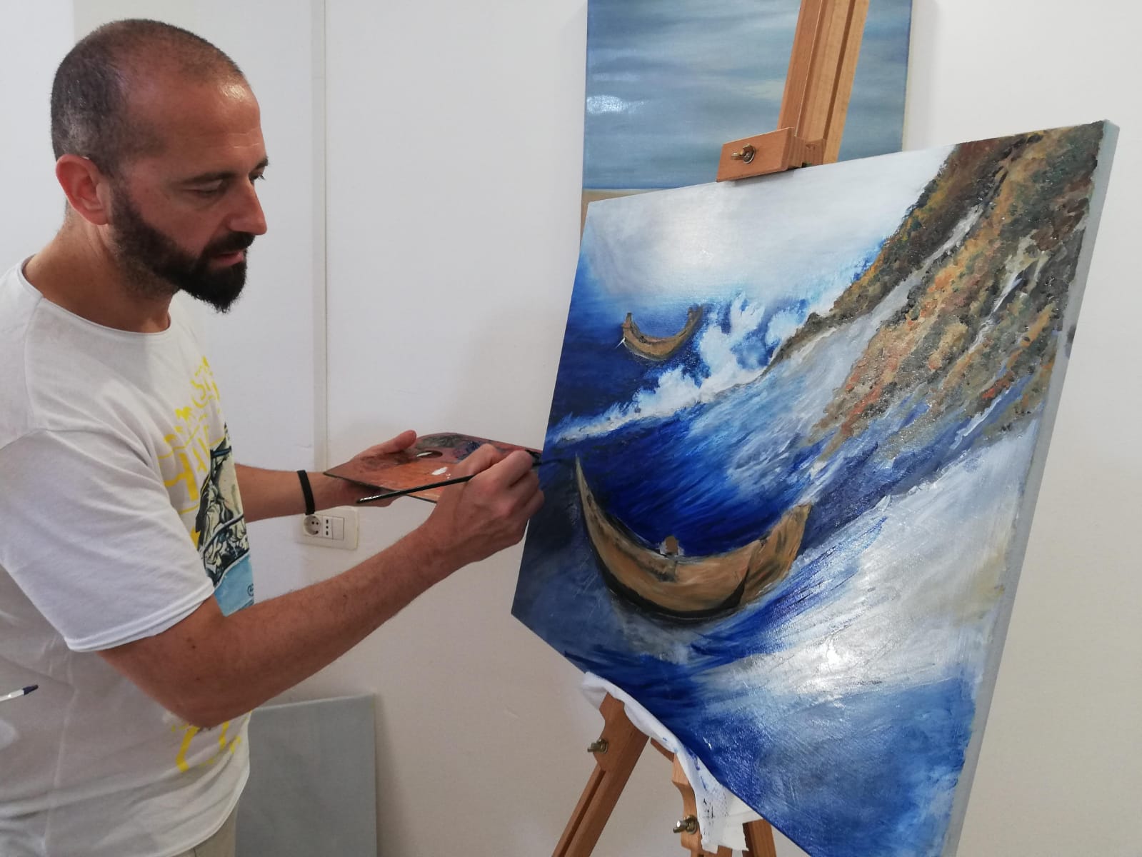 Painting at the easel.