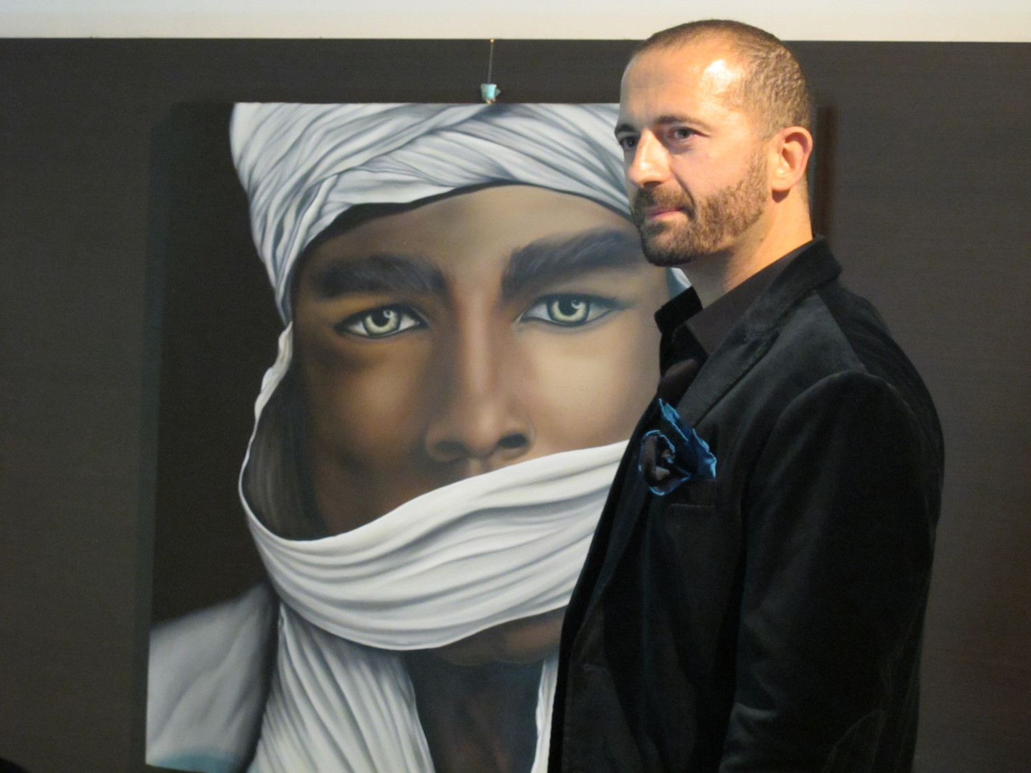 The artist alongside an artwork, archive photograph.