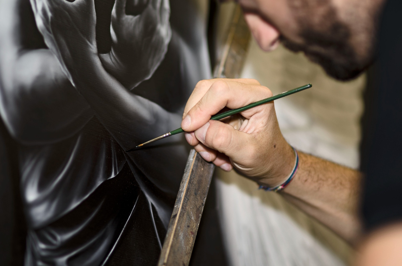 A detail of painting with a brush, archive photograph.